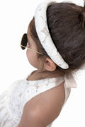 A matching hair bow for the ivory lace dress