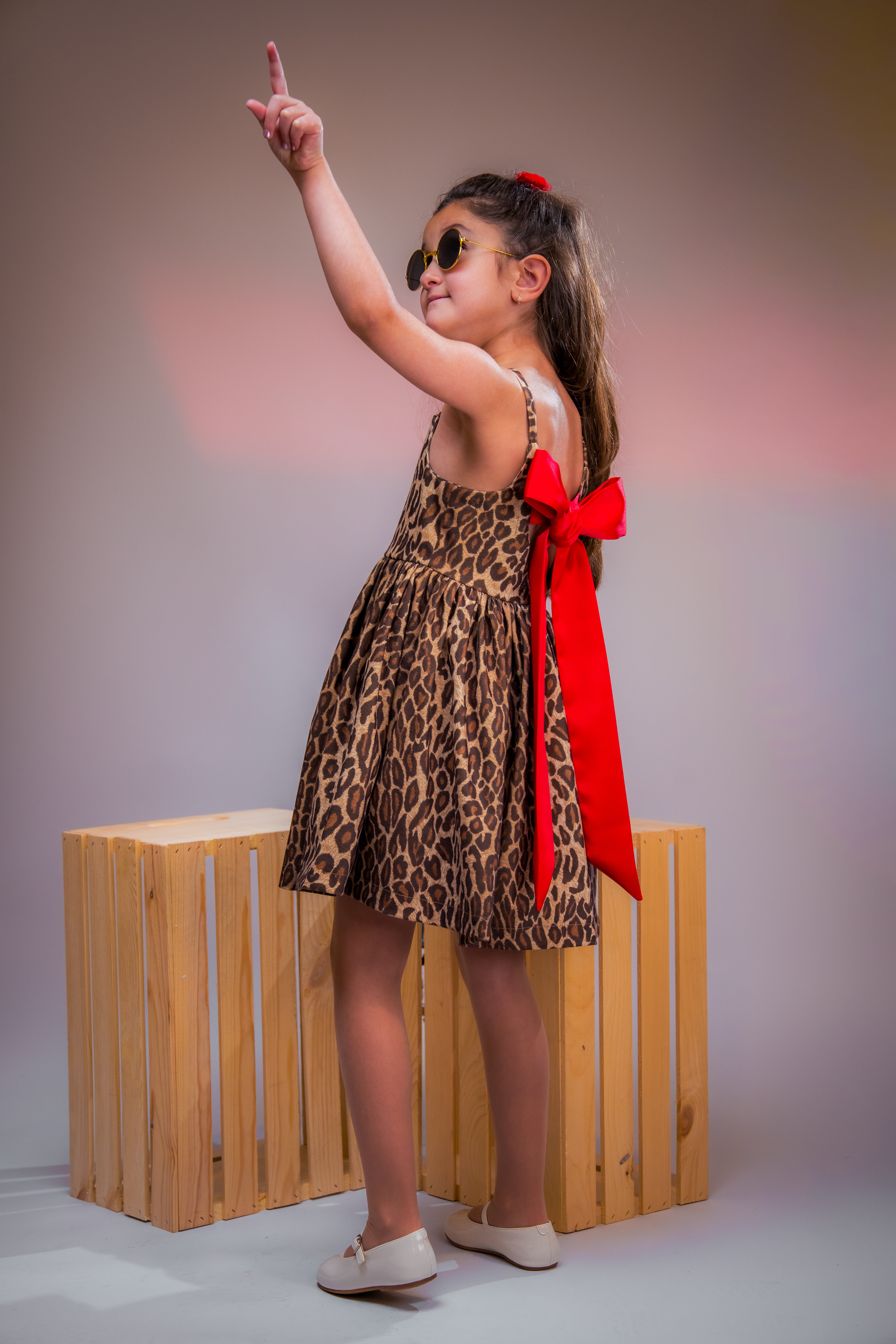 Leopard-print dress with a bold red bow