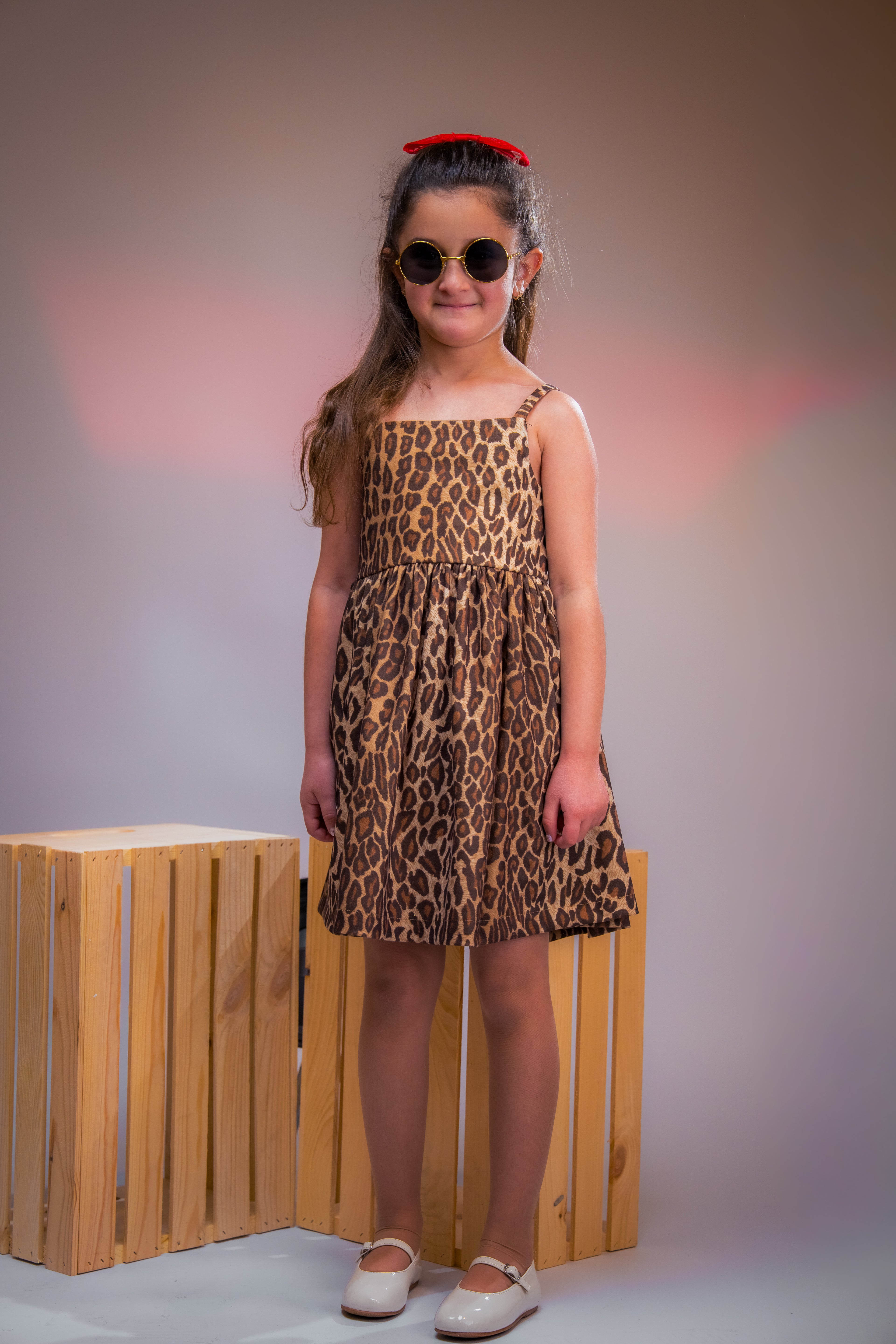 Leopard-print dress with a bold red bow