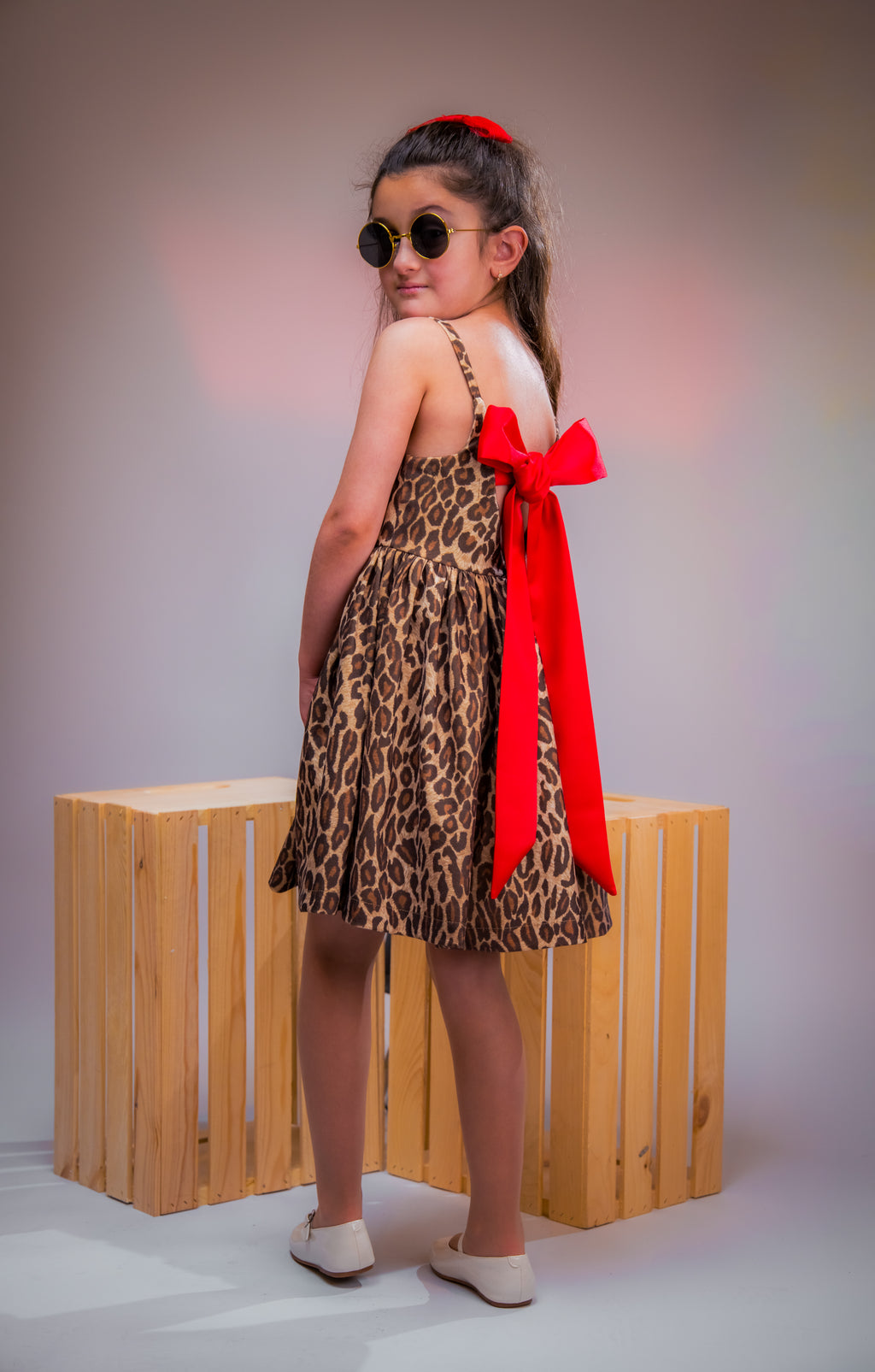 Leopard-print dress with a bold red bow